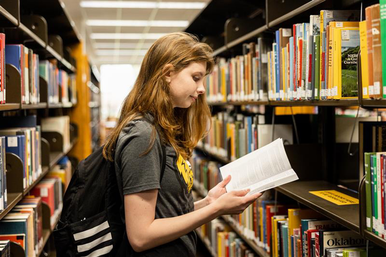 Two people studying at a desk in the library